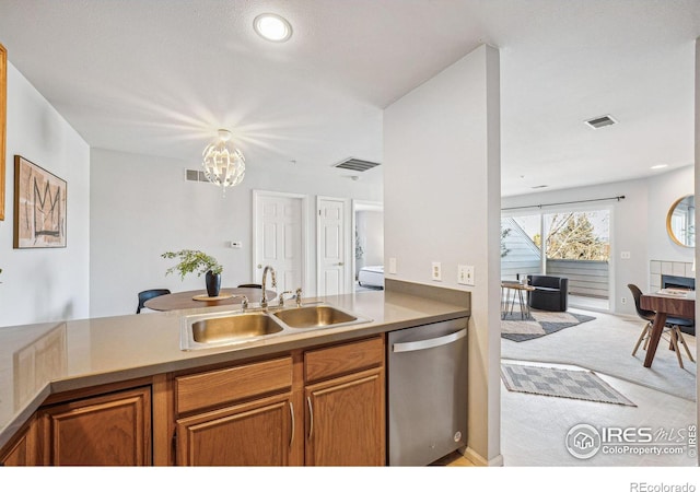 kitchen with a sink, light carpet, visible vents, and stainless steel dishwasher