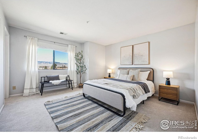 carpeted bedroom with baseboards and visible vents