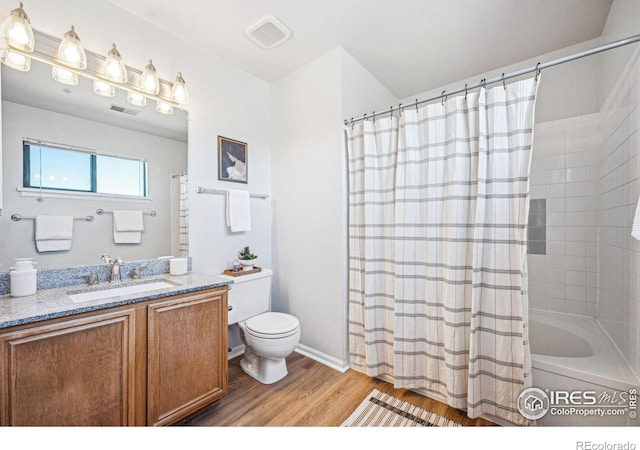 bathroom with toilet, wood finished floors, visible vents, and shower / bathtub combination with curtain