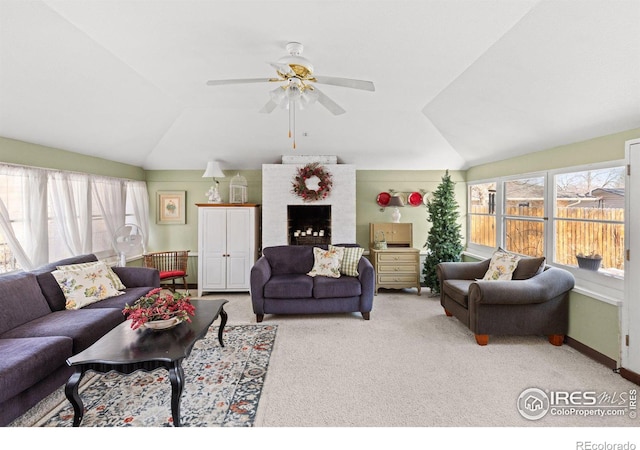 living room with lofted ceiling, a ceiling fan, and carpet