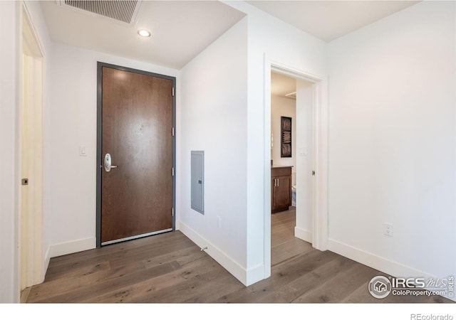 entrance foyer featuring baseboards, visible vents, and wood finished floors