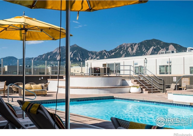 community pool featuring a patio area and a mountain view