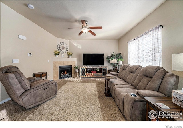 carpeted living area featuring a ceiling fan and a tile fireplace