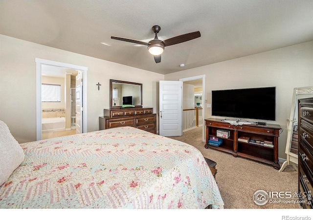 carpeted bedroom featuring ceiling fan and ensuite bath