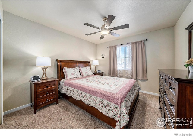 carpeted bedroom with a ceiling fan and baseboards