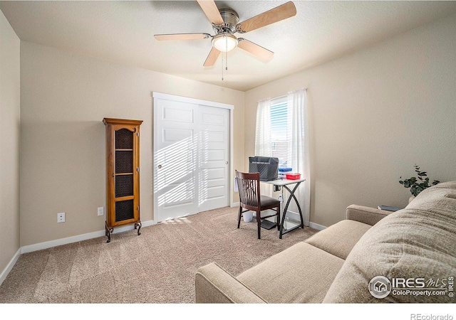 office space featuring carpet, baseboards, and ceiling fan