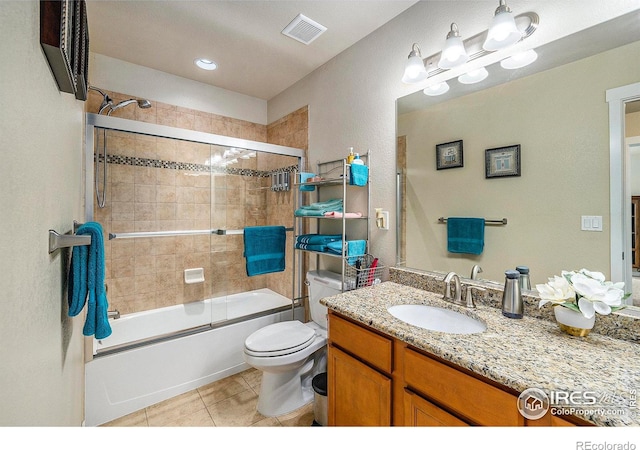 full bathroom with visible vents, bath / shower combo with glass door, toilet, tile patterned flooring, and vanity