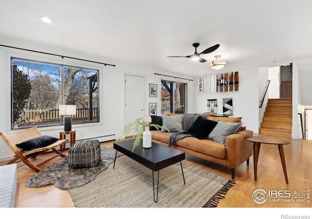 living room featuring stairway, a wealth of natural light, and light wood-style flooring