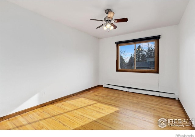 empty room with a baseboard heating unit, ceiling fan, light wood-style flooring, and baseboards