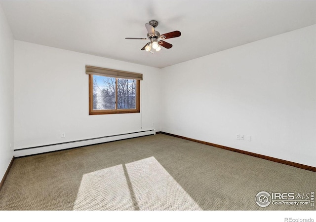 carpeted spare room with a baseboard radiator, baseboards, and ceiling fan