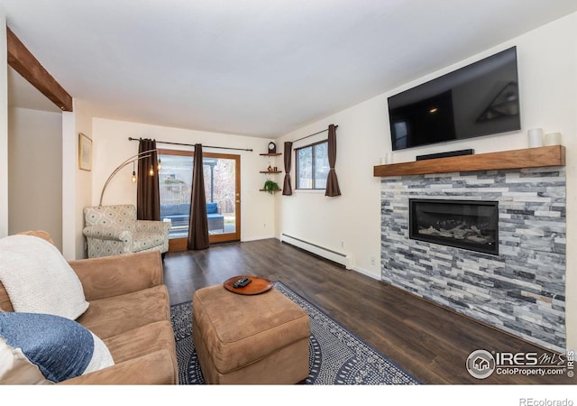 living room with a glass covered fireplace, baseboards, baseboard heating, and wood finished floors