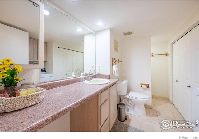 bathroom with toilet, visible vents, a closet, and vanity