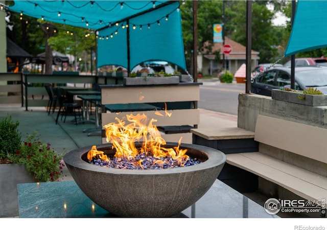 exterior space featuring an outdoor fire pit and a patio area