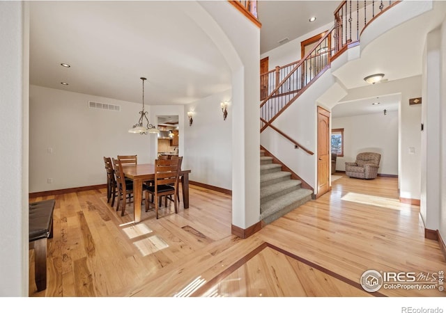 dining space featuring recessed lighting, wood finished floors, visible vents, baseboards, and stairway