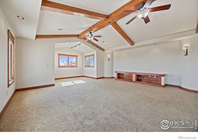 unfurnished living room featuring lofted ceiling with beams, carpet, a ceiling fan, and baseboards