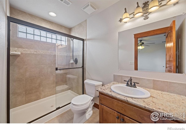 full bathroom featuring toilet, a shower stall, visible vents, and vanity