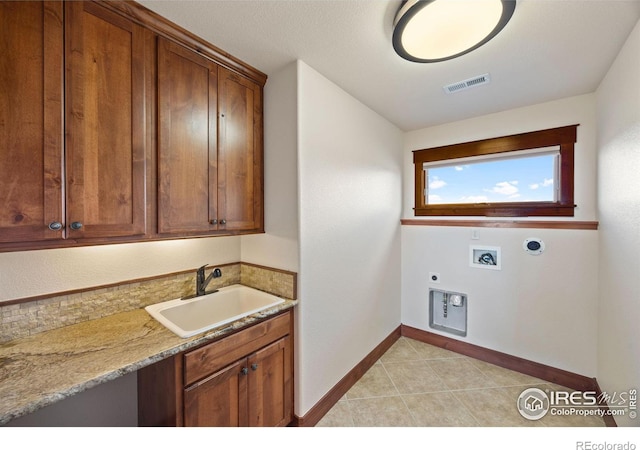 laundry room featuring hookup for a washing machine, a sink, visible vents, cabinet space, and electric dryer hookup