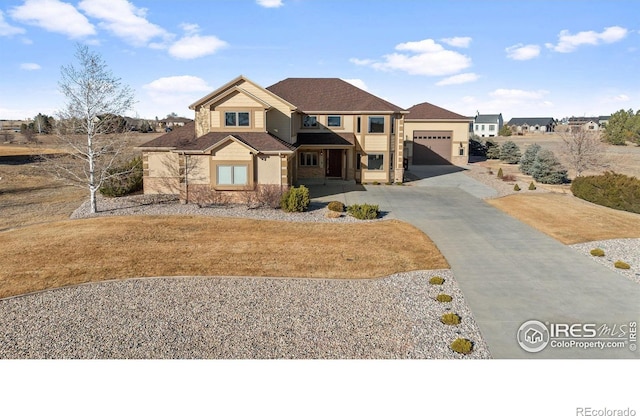 view of front facade featuring concrete driveway and an attached garage