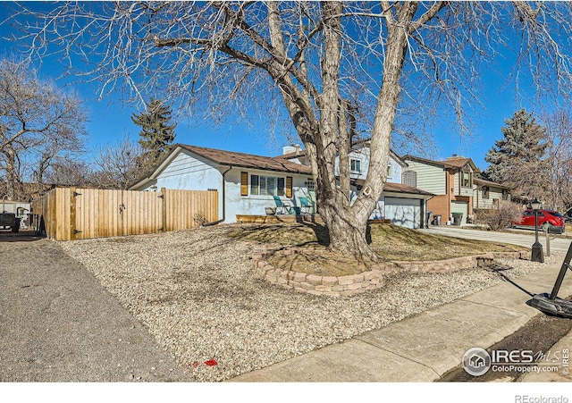 view of front of property with a garage, a gate, fence, and concrete driveway