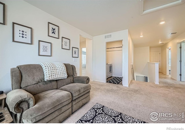 carpeted living area featuring visible vents