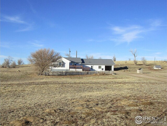 view of front of home with a garage and fence