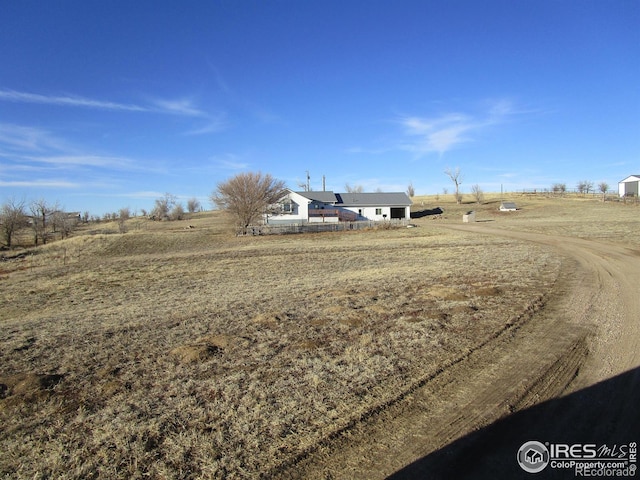 view of yard with a rural view