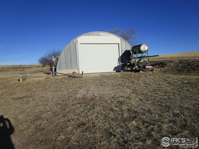 view of outbuilding with an outbuilding and a rural view