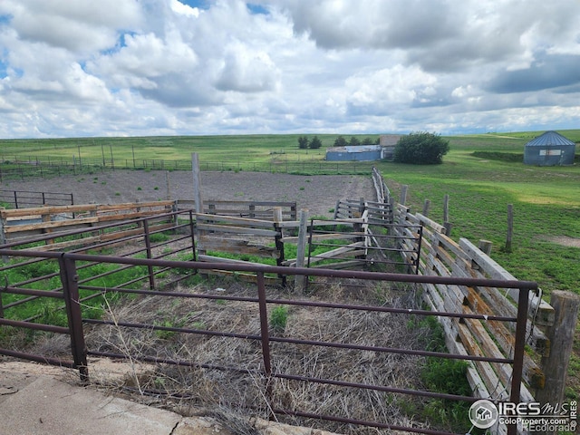 view of yard with fence and a rural view