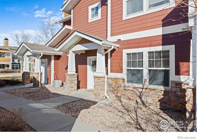 entrance to property with stone siding