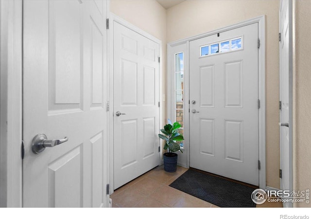 entryway with light tile patterned floors