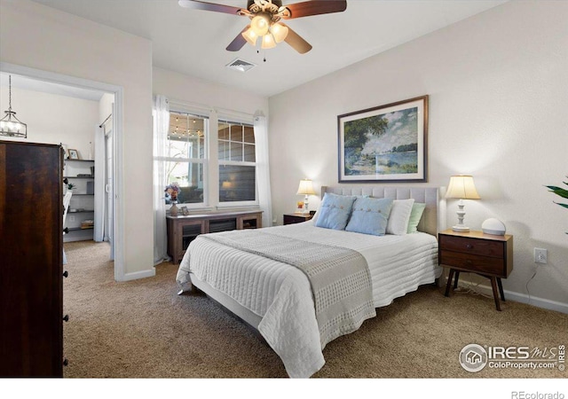 carpeted bedroom with ceiling fan, visible vents, and baseboards