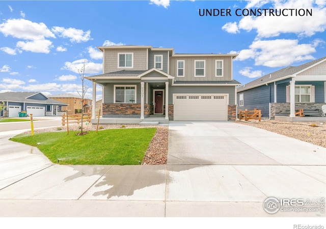 view of front of property featuring a garage, a front lawn, and concrete driveway