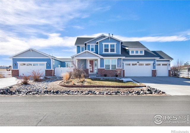 craftsman inspired home featuring brick siding, fence, and an attached garage