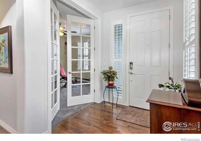 entrance foyer with ceiling fan, baseboards, wood finished floors, and french doors