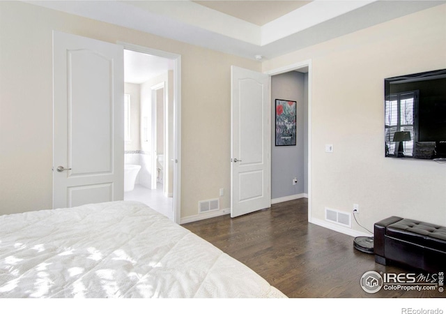 bedroom featuring baseboards, visible vents, and wood finished floors