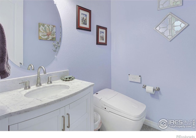 half bathroom with toilet and vanity