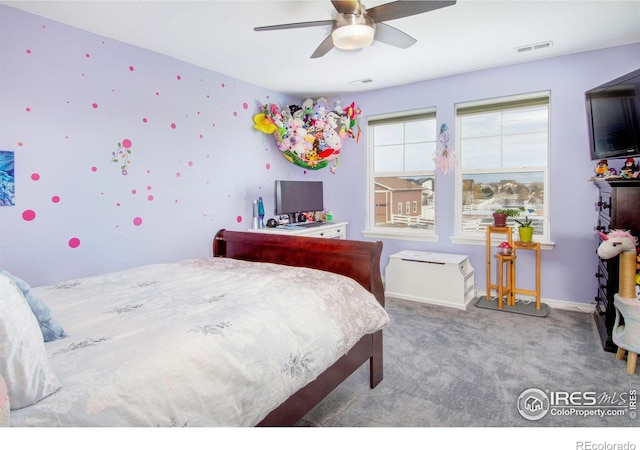 carpeted bedroom with baseboards, visible vents, and a ceiling fan