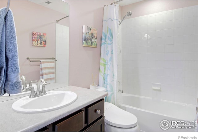 full bath with vanity, shower / bath combo with shower curtain, and toilet