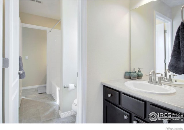 bathroom with baseboards, visible vents, vanity, and toilet