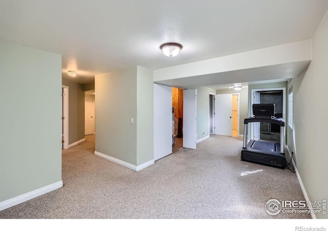 workout room with carpet and baseboards