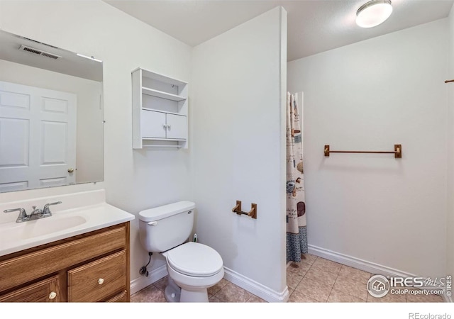 bathroom with toilet, tile patterned floors, visible vents, and vanity