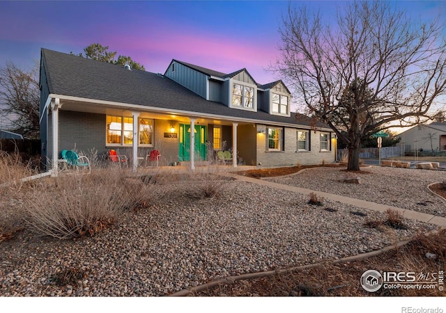 view of front of property featuring brick siding and board and batten siding