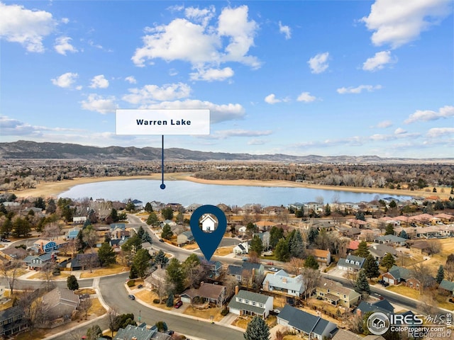 aerial view featuring a water and mountain view