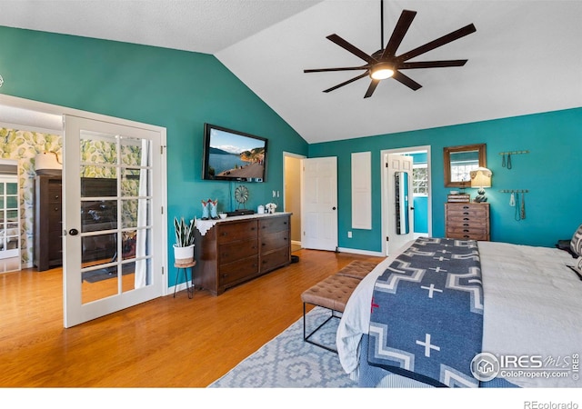 bedroom with ceiling fan, baseboards, vaulted ceiling, and wood finished floors