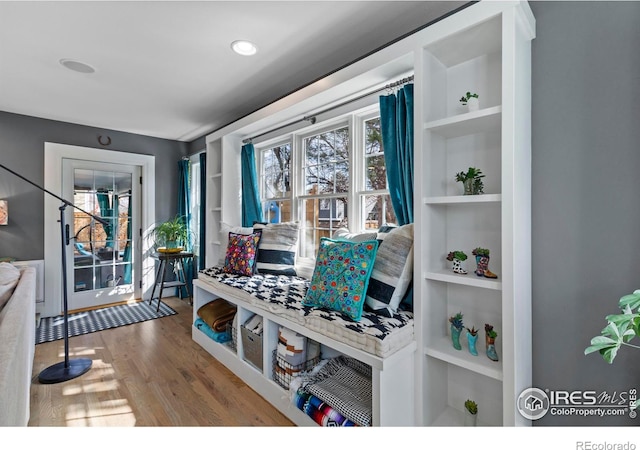 mudroom with built in shelves and wood finished floors