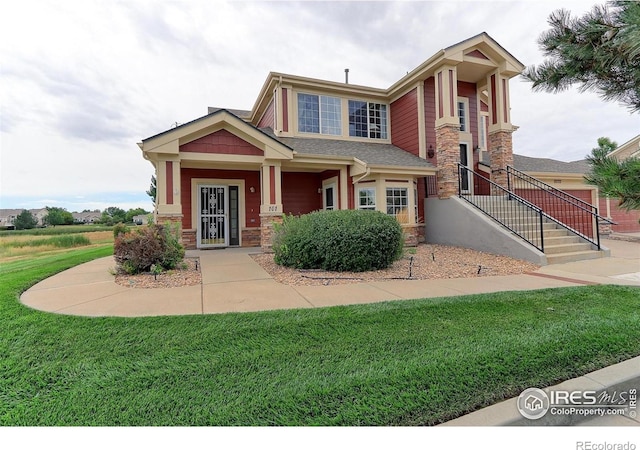 view of front of property featuring stone siding and a front lawn