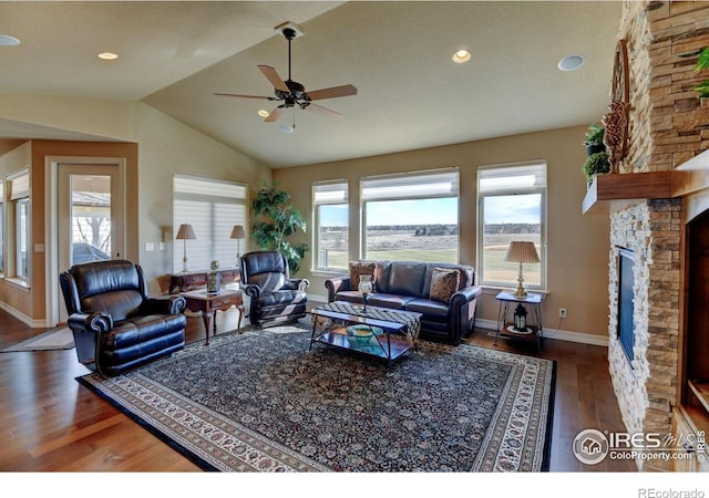 living area with a fireplace, lofted ceiling, recessed lighting, wood finished floors, and baseboards