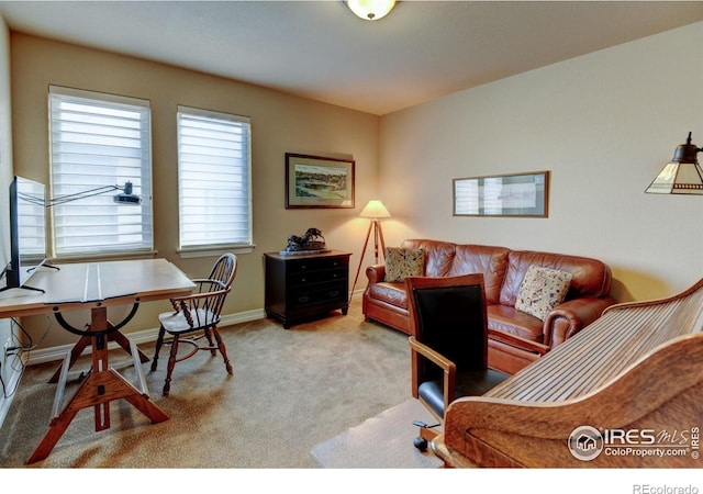 carpeted office featuring baseboards