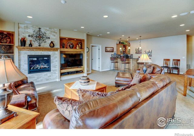 carpeted living room featuring baseboards, a fireplace, built in features, and recessed lighting