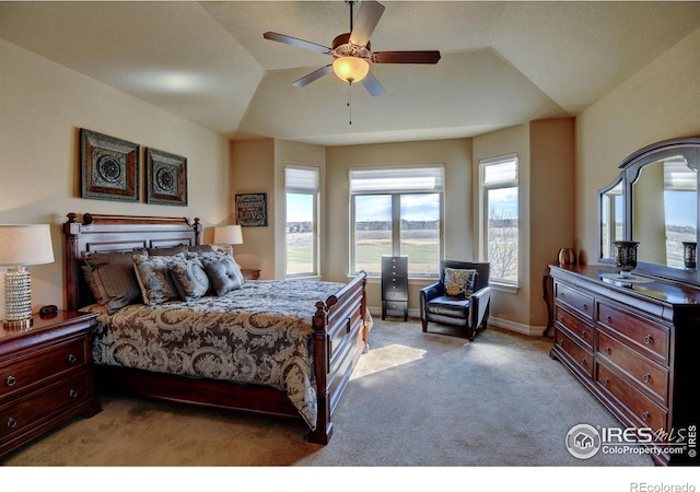 bedroom featuring light carpet, lofted ceiling, a ceiling fan, and baseboards